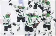  ?? JASON FRANSON— THE ASSOCIATED PRESS ?? Dallas Stars’ Corey Perry, center, is congratula­ted for his game-winning goal against the Tampa Bay Lightning in the second overtime of Game 5of the Stanley Cup Finals.