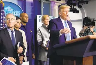  ?? Evan Vucci Associated Press ?? PRESIDENT TRUMP speaks during a news briefing with the coronaviru­s task force.