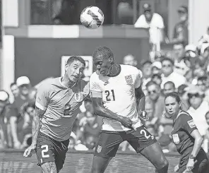  ?? DENNY MEDLEY/ USA TODAY SPORTS ?? The USMNT’s Tim Weah, right, and Uruguay’s Jose Gimenez head the ball during a friendly Sunday at Children’s Mercy Park.