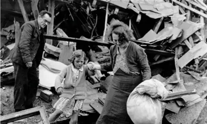  ??  ?? The Widdecombe family searching the rubble of their house in Plymouth after it was destroyed byGerman bombers in 1941. Photograph: Bert Hardy/Getty Images