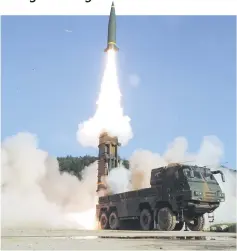  ??  ?? This handout photo provided by South Korean Defence Ministry in Seoul shows South Korea’s Hyunmu-2 Missile System firing a tactical ballistic missile into the East Sea from an undisclose­d location on South Korea’s east coast during a South Korea-US...