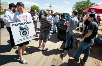  ?? Herald photo by Ian Martens ?? Striking workers begin to disperse from a crossing near the Churchill Industrial Yard office Wednesday after learning of a tentative agreement between the Teamsters Canada Rail Conference and Canadian Pacific Rail, less than a day after the strike...