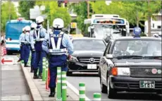  ?? AFP ?? Police officers check traffic near the G20 Finance Ministers and Central Bank Governors meeting site in Fukuoka on Friday.