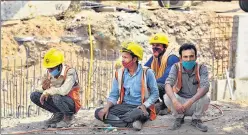  ?? RAJ K RAJ/HT PHOTO ?? Migrant workers at a constructi­on site at Pragati Maidan.