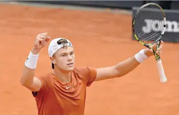 ?? — AFP ?? Denmark’s Holger Rune celebrates after defeating Norway’s Casper Ruud during their semifinal of the ATP Rome Open tournament at Foro Italico in Rome on Saturday.