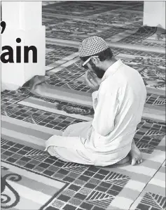  ??  ?? Faisal prays at the local mosque.