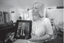  ?? Rick Bowmer, Associated Press file ?? Laurie Holt holds a photograph of son Joshua at her home in Riverton, Utah. Joshua Holt has been released from a jail in Venezuela after spending nearly two years behind bars on weapons charges.