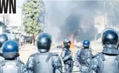  ?? ?? Senegalese police officers stand in formation on a road blocked with burning barricades during demonstrat­ions called by the opposition parties in Dakar on February 4, 2024.