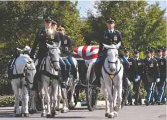  ?? ASTRID RIECKEN FOR THE Washington POST ?? The funeral procession Friday of Lt. Col. James Megellas, one of the 82nd Airborne Division’s most decorated soldiers, at Arlington National Cemetery. Megellas died April 2, 2020, at 103.