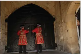  ?? (AP/Matt Dunham) ?? Yeomen Warders open the gates at the main entrance of the Tower of London earlier this month.