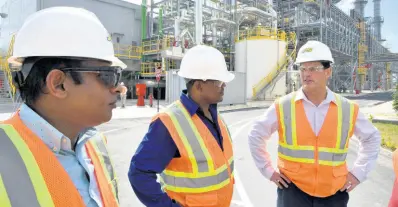  ?? FILE ?? Noel Watson (centre), plant manager, with Mo Majeed (left), chairman of SJPC Management Committee, and Emanuel DaRosa, president and CEO of the Jamaica Public Service Company, during a media tour of the 190 megawatt power plant at Old Harbour Bay, St Catherine, in January this year.