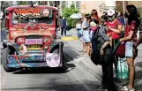  ??  ?? PASSENGERS wearing masks for protection against the coronaviru­s disease wait for a jeepney in Quezon City, July 3.