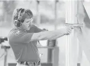  ?? Family photo ?? A young Clint Greenwood practices shooting. “What motivated him was the interest of truth,” said former Harris County Sheriff Adrian Garcia.