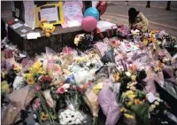  ?? PICTURE: AP ?? A woman places flowers after the suicide attack at a pop concert that left 22 people dead in Manchester.