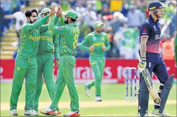  ?? AFP ?? Pakistan's Hasan Ali (left) celebrates the wicket of Ben Stokes with teammates in Cardiff on Wednesday.