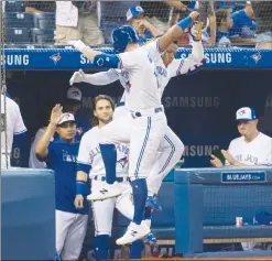  ?? Canadian Press photo ?? Toronto Blue Jays' Randall Grichuk and Vladimir Guerrero Jr. celebrate after hitting back to back home runs against the Seattle Mariners in the third inning of their American League MLB baseball game in Toronto Friday.