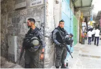  ?? (Marc Israel Sellem/The Jerusalem Post) ?? BORDER POLICE officers stand guard in the Muslim Quarter of Jerusalem’s Old City yesterday.