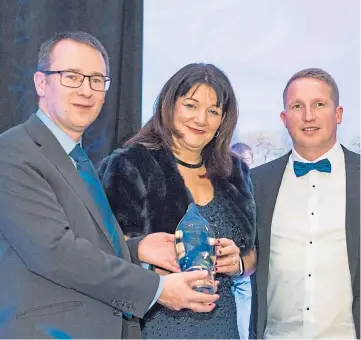  ??  ?? ACCOLADE: NFU Scotland chief executive Scott Walker presents Margaret Hebbourn and Marc Robb with the award in 2020 as the Perth office excels in its work.