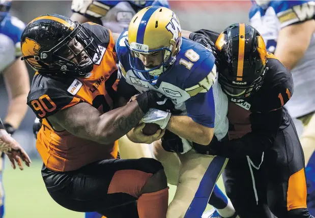  ?? — PHOTOS: THE CANADIAN PRESS FILES ?? B.C. Lions’ Odell Willis, right, sacks Blue Bombers QB Alex Ross, centre, as Davon Coleman helps bring him down in Vancouver on June 8. Coleman has made the Lions ‘a better football team,’ says head coach Wally Buono.