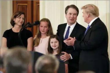  ?? EVAN VUCCI — THE ASSOCIATED PRESS ?? President Donald Trump greets Judge Brett Kavanaugh his Supreme Court nominee, in the East Room of the White House, Monday in Washington.