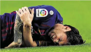  ?? EPA ?? Am Boden zerstört: Lionel Messi hält sich nach einem Sturz den gebrochene­n Arm.