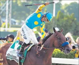  ?? Al Bello
Getty Images ?? VICTOR ESPINOZA soaks in glory atop American Pharoah on Saturday. The Triple Crown-winning horse is expected to bring six-figure stud fees.