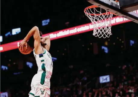  ?? Cole Burston/Getty Images ?? Andre Jackson Jr. of the Milwaukee Bucks dunks against the Toronto Raptors during the second half at Scotiabank Arena on Nov. 1 in Toronto.