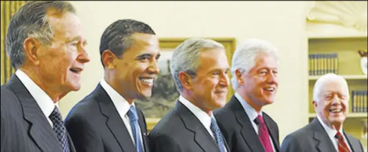  ?? J. Scott Applewhite The Associated Press ?? Former presidents react to the passing of President George H.W. Bush, left: “His administra­tion was marked by grace, civility, and social conscience.” — Jimmy Carter, right. “I just loved him.” — Bill Clinton, second from right.