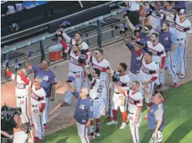  ?? NAM Y. HUH/AP ?? White Sox players and coaches tip their caps to Ken “Hawk” Harrelson after the game Sunday against the Cubs at Guaranteed Rate Field.