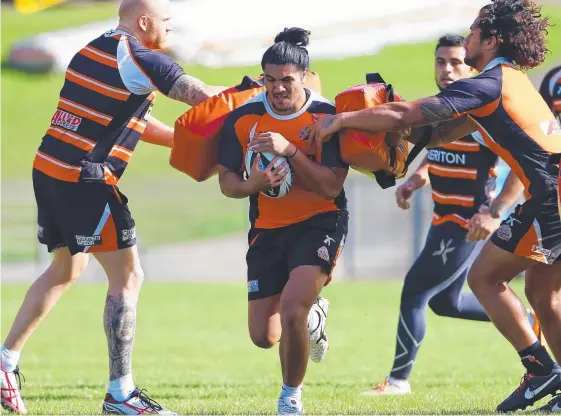  ??  ?? Runaway Bay's Andrew Vela, pictured during his days at the Wests Tigers in 2014, has a touching story behind his hair.