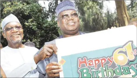  ?? JULIUS ATOI./THISDAY IMAGES ?? L-R: Senate Leader, Senator Yahaya Abdullahi, and President of the Senate, Senator Ahmad Lawan, displaying the card presented to the Senate President on his 61st birthday by the Senate Press Corps in Abuja... yesterday