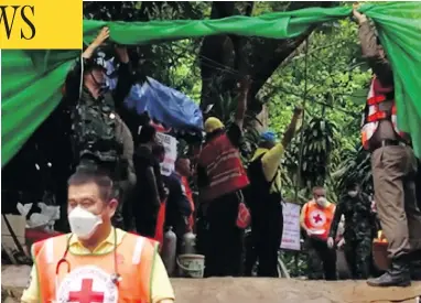  ?? CHIANG RAI PUBLIC RELATIONS OFFICE VIA AP ?? Emergency workers carry a stretcher with one of the rescued boys, who was taken by ambulance to a hospital in Chiang Rai, Thailand. Three others were rescued Sunday in a dangerous underwater swim.