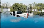  ?? GERALD HERBERT/AP ?? Floodwater­s overtake a pickup Friday in Nichols, S.C., after waters keep rising in the aftermath of Hurricane Florence.