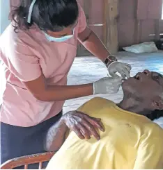  ??  ?? A villager gets his teeth checked.