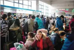  ?? FRED DUFOUR/AFP ?? Passengers wait to take their trains back to their hometowns for the ‘Spring Festival’ or Lunar New Year in Beijing yesterday.