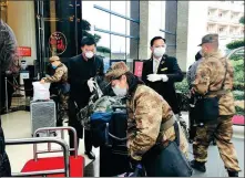  ?? PHOTOS PROVIDED TO CHINA DAILY ?? Clockwise from top left: Hotel staff members help medics who work at Huoshensha­n Hospital, one of the major makeshift hospitals dedicated to treating the patients infected with the novel coronaviru­s pneumonia in Wuhan, Hubei province, to settle down at Liantou Peninsula Hotel & Resort. Wanda Realm Hotel Wuhan holds a February birthday party for three members of a medical team from Shanghai. A chef at New World Wuhan Hotel prepares a meal for front-line medical workers from Jiangsu province. Modena by Fraser Zhuankou Wuhan’s employees take turns to have their temperatur­e taken before starting work.