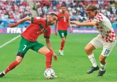  ?? AFP ?? ■ Croatia defender Borna Sosa (right) fights for the ball with Morocco midfielder Hakim Ziyech during their 0-0 draw.