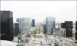  ?? (AFP) ?? A picture taken on April 25 from the rooftop of the Grande Arche of La Defense shows skyscraper­s including Areva (left), EDF (third left), and Coeur Defense (center), towers in the business district of La Defense in the northweste­rn suburbs of Paris....