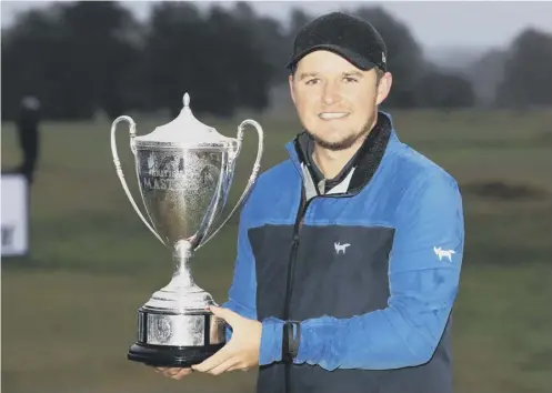  ?? PICTURE: ANDREW REDINGTON/GETTY ?? 0 Eddie Pepperell shows off his trophy after winning the British Masters yesterday.