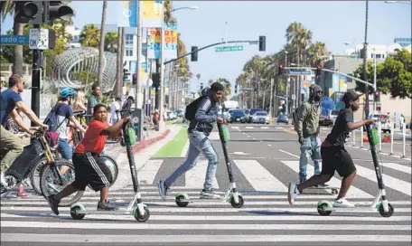  ?? Photograph­s by Mel Melcon Los Angeles Times ?? WITH SO many e-scooter firms operating under different geofencing rules in contiguous municipali­ties, riders sometimes get confused.