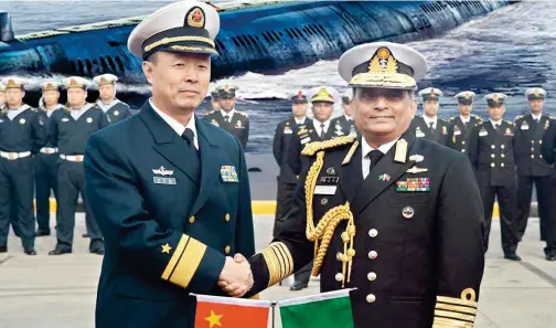  ??  ?? Chief of Naval Staff Admiral Nizamuddin Ahmed (right) receives two first-ever Chinese submarines at Liaonan Shipyard in China on November 14, 2016. (Photo Courtesy: Bangladesh Navy)