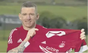  ??  ?? 3 Jonny Hayes shows off his new Aberdeen strip after signing for the Pittodrie club yesterday. The winger was a free agent after being released by Celtic.