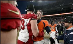  ?? AARON ONTIVEROZ — THE DENVER POST ?? Denver quarterbac­k Brett Rypien embraces Arizona defensive lineman J.J. Watt after the Broncos’ win at Empower Field at Mile High on Sunday.