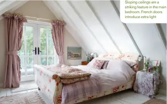  ??  ?? Sloping ceilings are a striking feature in the main bedroom. French doors introduce extra light