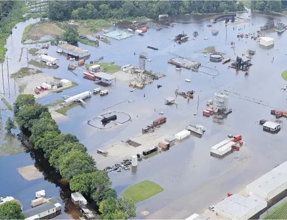  ?? BILL FEIG/ THE ADVOCATE VIA AP ?? Flood water covers the site of the Louisiana State University’s Fire and Emergency Training Institute after heavy rains in Baton Rouge on Aug. 16.