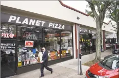  ?? Tyler Sizemore / Hearst Connecticu­t Media ?? Planet Pizza and Olive Branch, two businesses near the Greenwich train station, could be affected by the plan to redevelop the area.