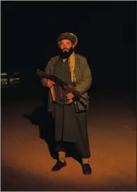  ?? ?? A Taliban fighter poses for a photo Nov. 27 at a checkpoint in Herat.