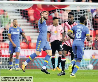  ??  ?? Stuart Dallas celebrates scoring Leeds’ second goal of the game