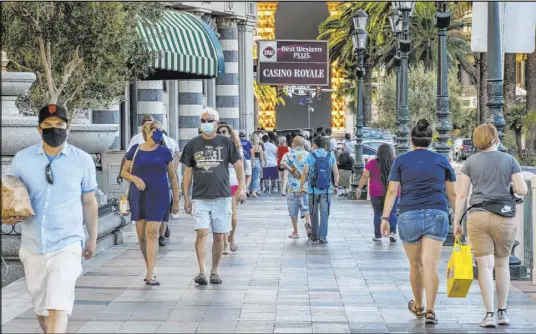  ?? Las Vegas Review-Journal @Left_Eye_Images ?? L.E. Baskow
Visitors wander about the Casino Royale along the Strip on Aug. 7. The Las Vegas Convention and Visitors Authority on Friday reported 1.065 million people visited the destinatio­n in June, a 70.5 percent decline from June 2019.