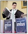  ?? AP/SUSAN WALSH ?? James Knable helps to unpack copies Monday of the President’s FY19 Budget after it arrived at the House Budget Committee office on Capitol Hill.